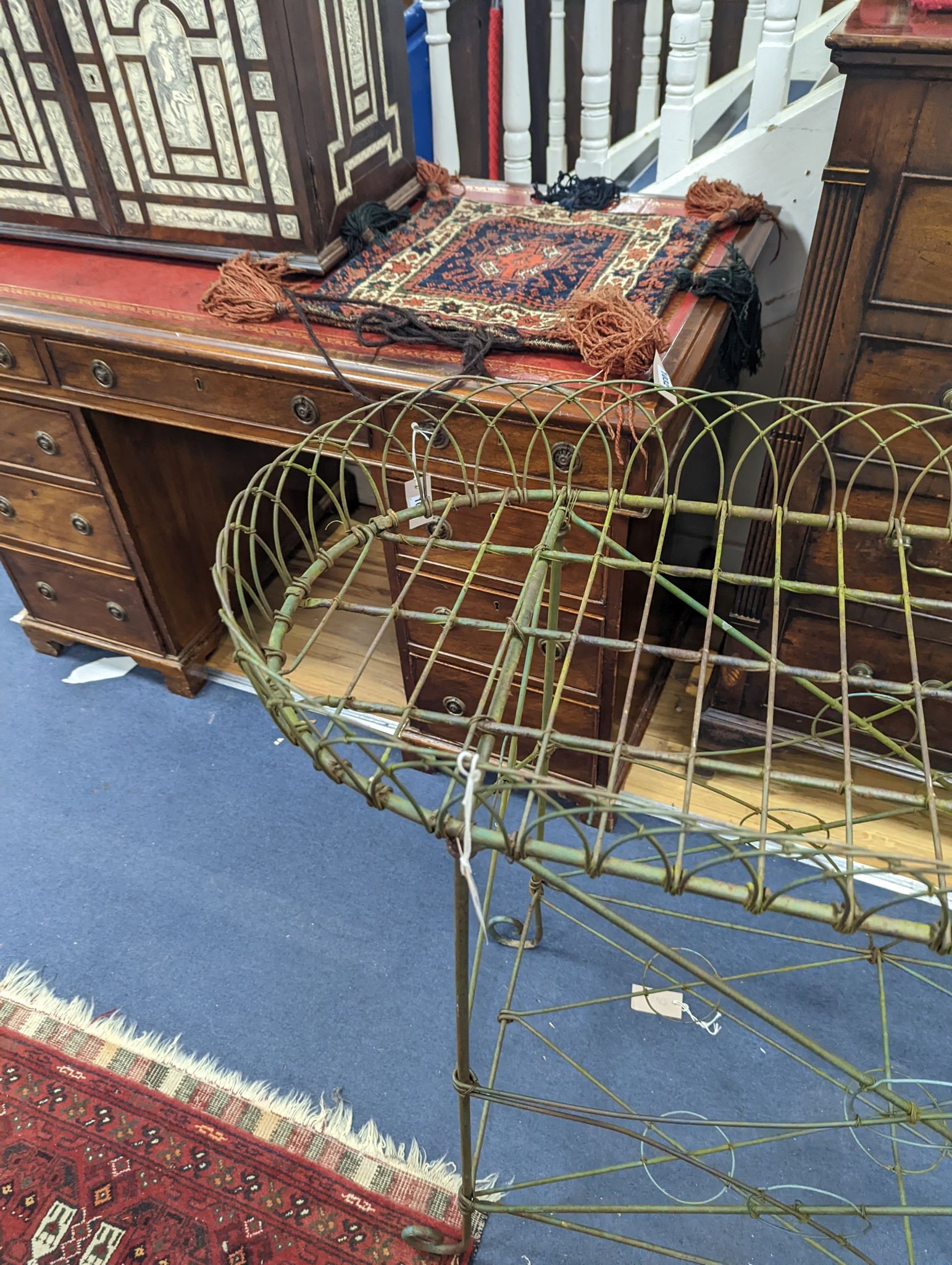 A wirework pot stand, width 122cm, depth 43cm, height 90cm